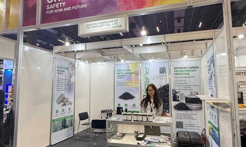 The Purestar team at Booth G113A, FISP 2026, São Paulo Expo — activated carbon samples on display